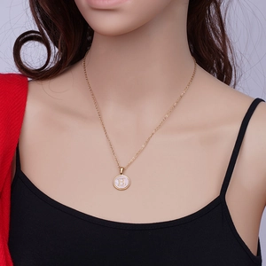 Close-up of 18k gold-plated stainless steel necklace with pink shell H letter pendant