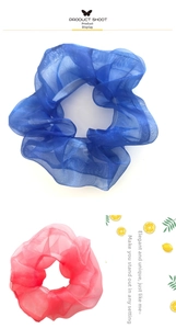 Detail of navy blue and pink organza scrunchies showing sheer fabric and soft texture