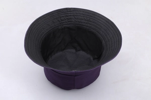 Detail view showing the purple cotton bucket hat with black lining and durable brim stitching
