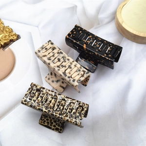 Detail view of rectangular tortoise shell and leopard print acetate claw clips for hair