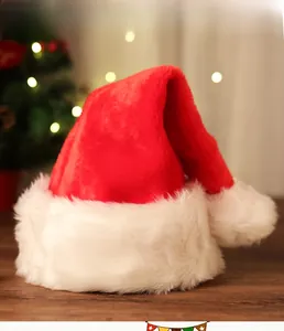 Classic red plush Christmas hat with white faux fur trim on a cozy wooden background