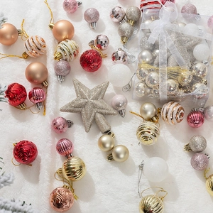 Christmas ball ornament set with glitter stars on soft white faux fur background