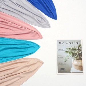 Detail of soft mercerized cotton scarves in royal blue, grey, pink, and apricot colors