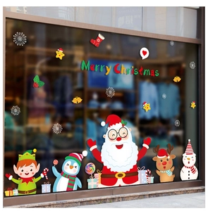Detail of colorful Christmas window stickers with Santa Claus and reindeer on glass display