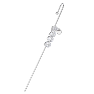 Detailed macro of silver LOVE earrings with clear cubic zirconia and heart pendant