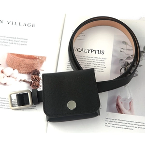 Minimalist black belt with mini square pouch on magazine for a stylish fashion look