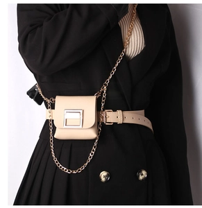 Close-up of a beige leather belt bag with silver metal buckle and fine chain strap detail