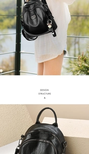 Detail of black PU backpack featuring multiple zipper pockets and heart-shaped metal charm