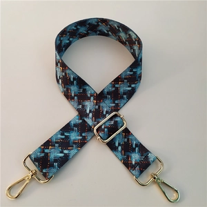 Close-up of bohemian wide adjustable shoulder strap with blue and orange houndstooth pattern
