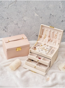 Detailed interior of three-tier jewelry box with drawer compartments and soft velvet lining