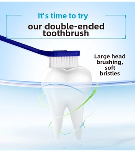 Dual-head pet toothbrush with soft bristles cleaning a tooth model for oral care