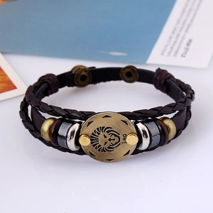 Macro shot of brown braided leather Leo bracelet with antique alloy zodiac charm