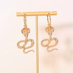 Retro golden cobra snake hoop earrings with detailed scale texture on T-stand