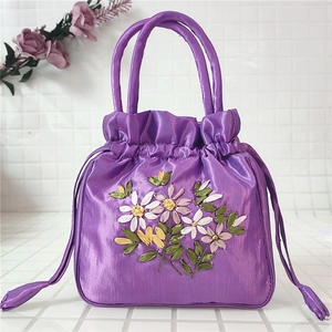 Purple satin drawstring bucket bag featuring vibrant 3D ribbon floral embroidery