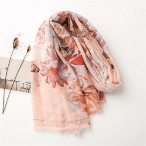 Pink orange cotton linen scarf featuring butterfly and floral prints with frayed edges