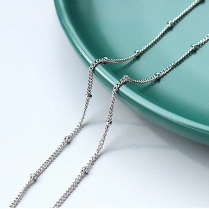 Detail of 1.5mm stainless steel beaded chain necklace with polished silver-tone finish