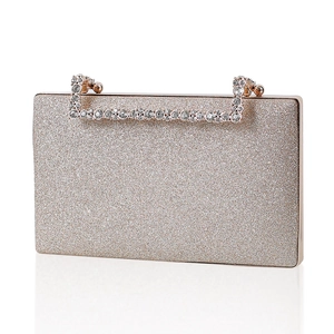 Champagne gold glitter evening clutch bag with rhinestone handle on white background