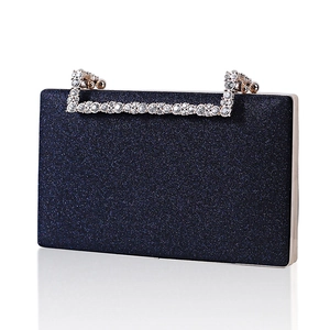 Navy blue glitter evening clutch bag with sparkling rhinestone handle on white background
