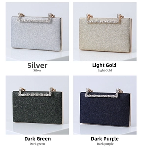 Detail showing glitter fabric texture and rhinestone handles on luxury evening clutch bags