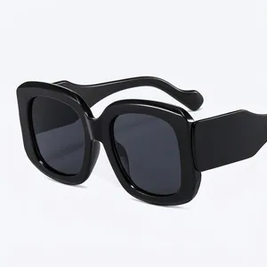 Fashionable oversized square black sunglasses with thick frames and retro street style