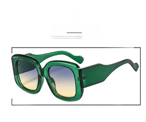 Detail close-up of green transparent oversized sunglasses with gradient lenses