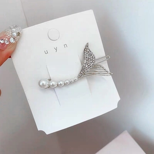 Elegant silver mermaid tail hair clip with white pearls and sparkling rhinestones