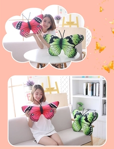 Detailed view of colorful red and green butterfly plush pillows in a cozy home setting