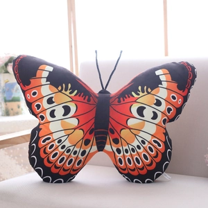 Macro detail of butterfly plush pillow shell with vibrant orange and black wing patterns