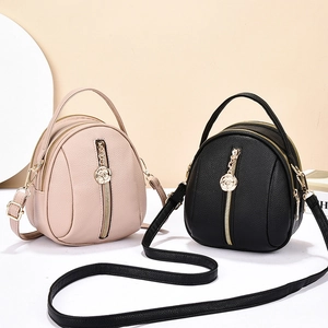 Minimalist textured leather crossbody bag with rose pendant and top handle in two colors