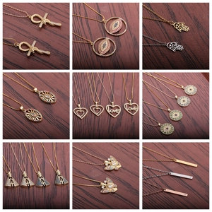 Collection of zircon heart lock and evil eye pendants in gold and silver plating