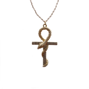 Golden Ankh cross necklace with snake detail and clear gemstones on white background