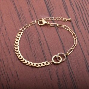 Gold bohemian bracelet featuring interlocking rings with colorful crystals and mixed chain links