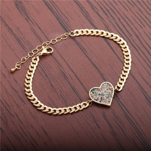 Gold Cuban chain bracelet featuring a heart pendant with colorful micro-set cubic zirconia