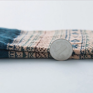 Thick vintage geometric rabbit wool blend socks for winter shown next to a coin for scale