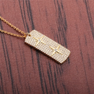 Golden rectangular bar necklace with micro-pave cubic zirconia and star patterns