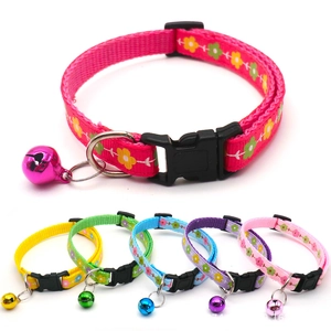 Detail of nylon pet collars with floral patterns, bells, and secure plastic buckles