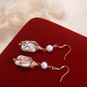 Handmade S925 silver hook earrings with baroque pearls on red velvet background