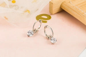 Detail view of S925 silver hoop earrings featuring clear round brilliant cut zircon stones
