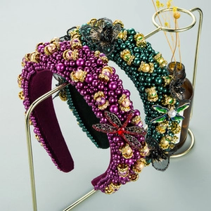 Macro detail of Baroque crystal headband featuring dragonfly and butterfly jewelry