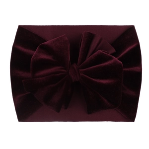 Detail of soft dark burgundy velvet headband for babies with large decorative bow