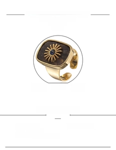 Detailed view of adjustable gold ring with sun pattern and natural tiger eye stone