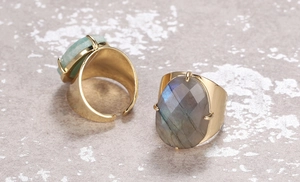 Macro shot of gold-plated open rings featuring faceted natural labradorite and green stone