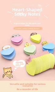 Close-up of heart-shaped sticky notes with cute animal toppers in pastel colors