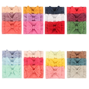 Detailed view of elastic nylon baby headbands with soft bows in diverse color sets