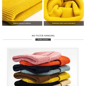 Detailed macro view of thick vertical rib knit texture and multi-color winter beanies