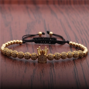 Adjustable woven bracelet with gold crown pendant and pave cubic zirconia beads