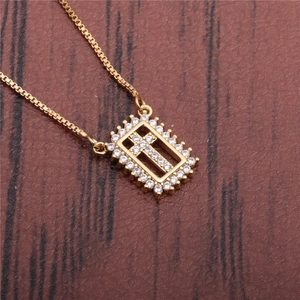 Gold cross necklace with micro-pave crystals in a rectangular open frame pendant