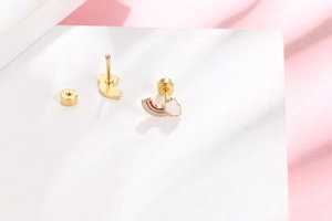 Detail of rainbow cloud stud earrings with secure screw back and gold finish