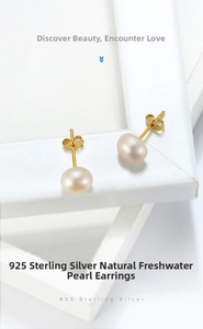Detail view of round natural freshwater pearls on 925 sterling silver earring studs