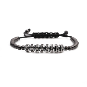 Adjustable woven bracelet with black beads and silver micro-paved cubic zirconia charms